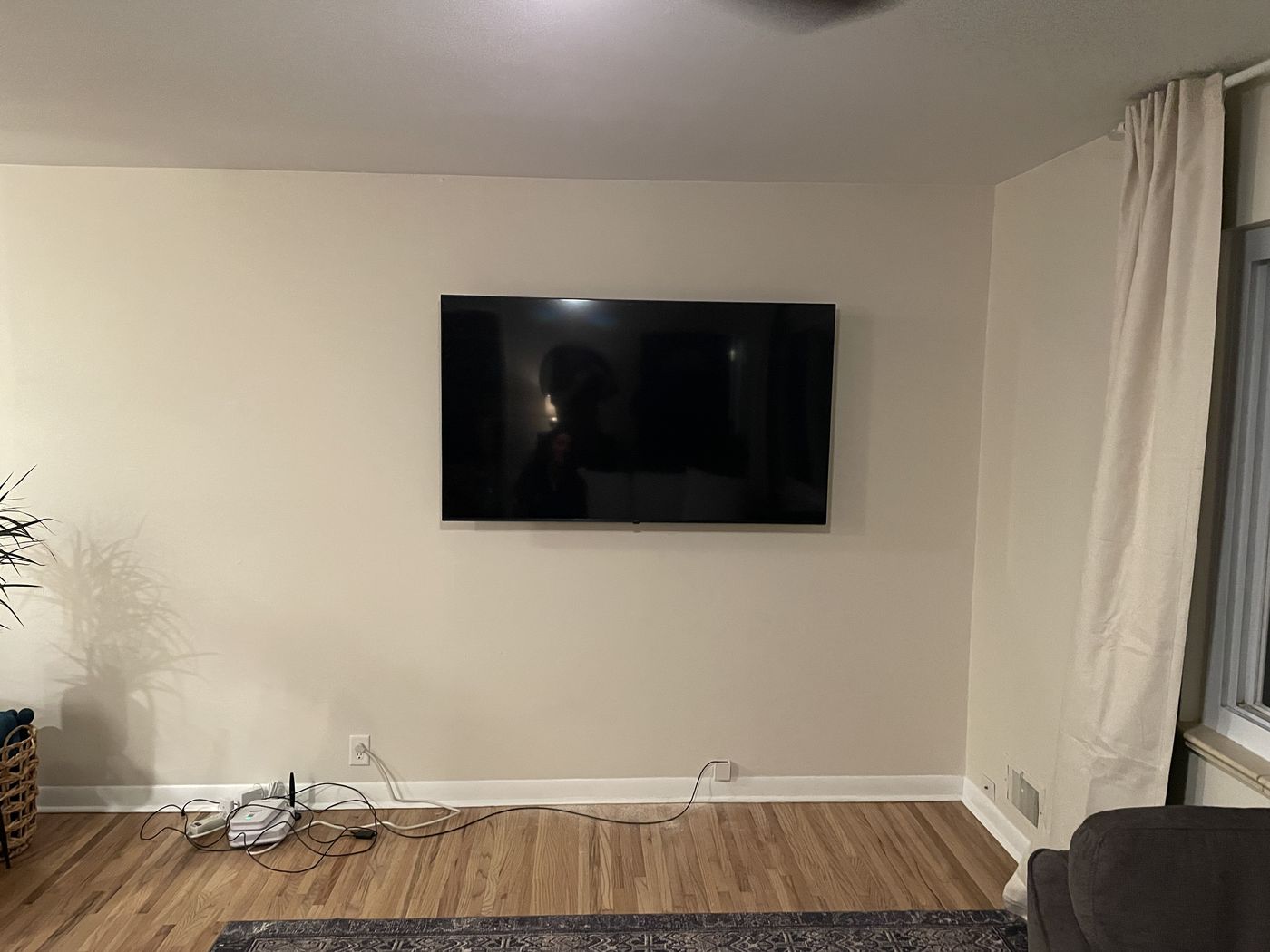 Living room TV mounted level on the wall